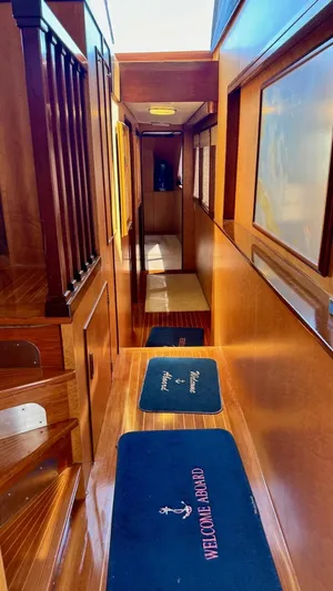 Adventurer Yacht Photos Pics Interior hallway of 1987 Burger 86 Raised Pilothouse yacht with wooden finishes.