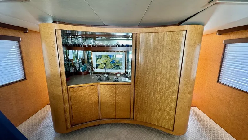 Adventurer Yacht Photos Pics Luxurious interior of 1987 Burger 86 Raised Pilothouse yacht with elegant wood cabinetry.