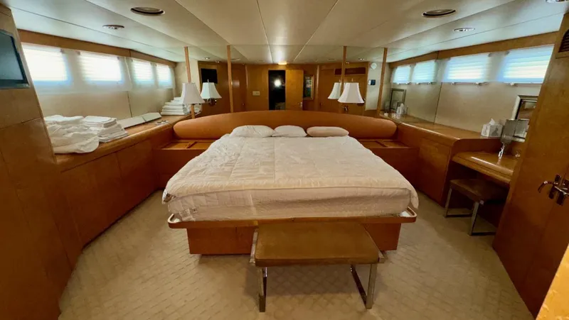 Adventurer Yacht Photos Pics Luxurious bedroom in 1987 Burger 86 Raised Pilothouse yacht with elegant wood finishes.