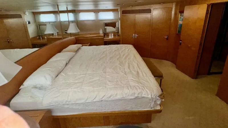 Adventurer Yacht Photos Pics Luxurious bedroom interior of 1987 Burger 86 Raised Pilothouse yacht with wood finishes.