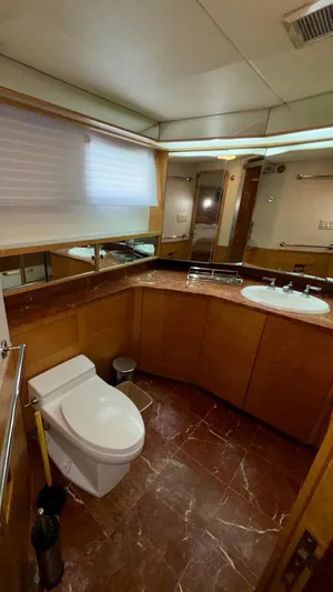 Adventurer Yacht Photos Pics Luxurious bathroom in 1987 Burger 86 Raised Pilothouse yacht with marble flooring and modern fixtures.