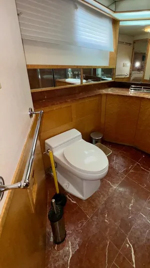 Adventurer Yacht Photos Pics Luxury yacht bathroom with marble flooring, wooden cabinetry, and modern fixtures on a 1987 Burger 86 Raised Pilothouse.