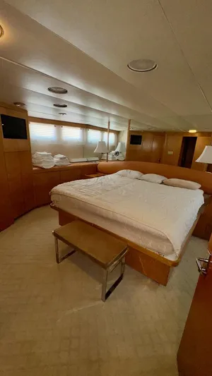 Adventurer Yacht Photos Pics Luxurious bedroom interior of 1987 Burger 86 Raised Pilothouse yacht with elegant wood paneling.