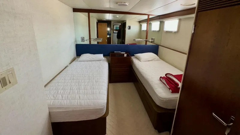 Adventurer Yacht Photos Pics Twin beds in a cozy cabin aboard a 1987 Burger 86 Raised Pilothouse yacht.