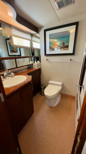 Adventurer Yacht Photos Pics Luxurious bathroom in 1987 Burger 86 Raised Pilothouse yacht with elegant decor and modern amenities.
