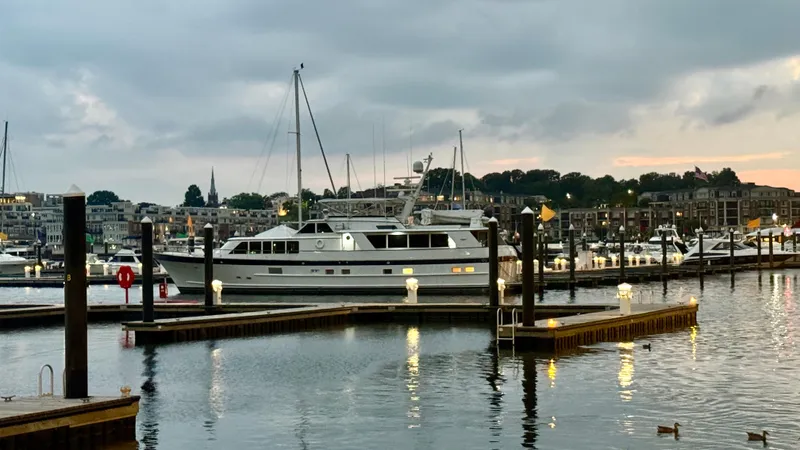 Adventurer Yacht Photos Pics Luxury yacht "Burger 86 Raised Pilothouse" docked at marina, evening view, 1987 model.