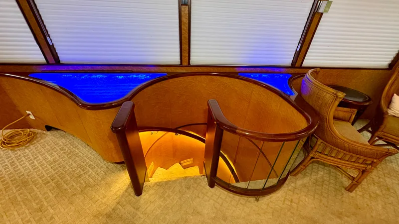 Adventurer Yacht Photos Pics Luxurious interior of 1987 Burger 86 Raised Pilothouse yacht with elegant wood and blue lighting.