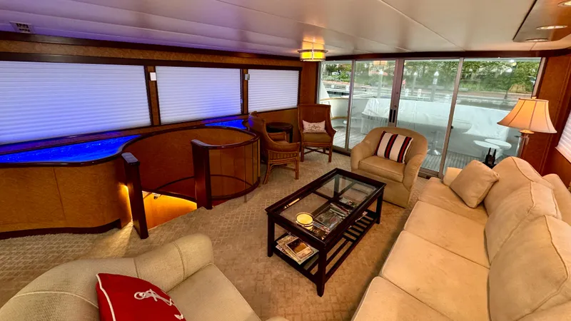 Adventurer Yacht Photos Pics Luxurious interior of 1987 Burger 86 Raised Pilothouse yacht with elegant seating and glass table.