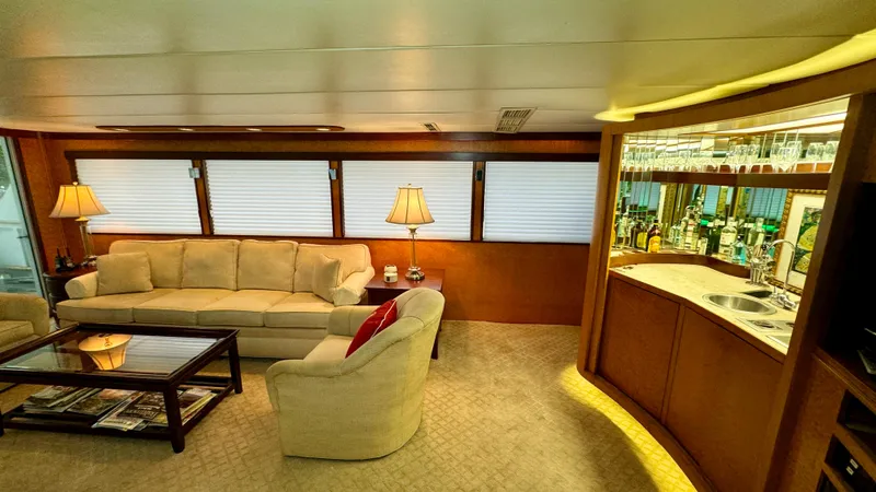 Adventurer Yacht Photos Pics Luxurious interior of 1987 Burger 86 Raised Pilothouse yacht with elegant seating and bar area.