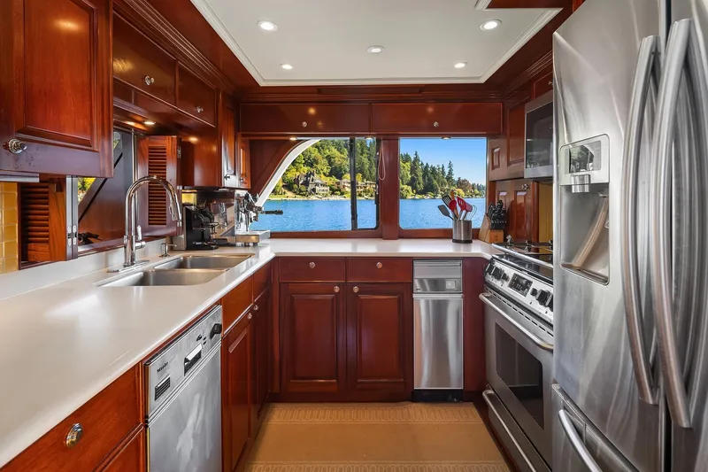 Jade Panama Yacht Photos Pics Luxurious kitchen on 2001 Rayburn Flush Deck yacht with stainless steel appliances and lake view.