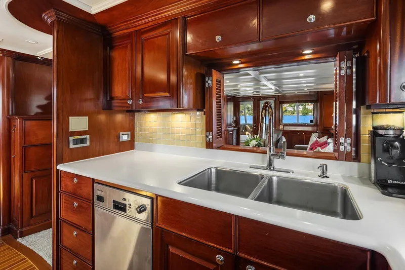 Jade Panama Yacht Photos Pics Luxurious 2001 Rayburn Flush Deck yacht kitchen with wood cabinetry and modern appliances.