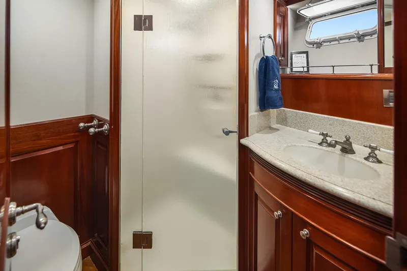 Jade Panama Yacht Photos Pics Luxurious bathroom on 2001 Rayburn Flush Deck yacht with wood accents and modern fixtures.