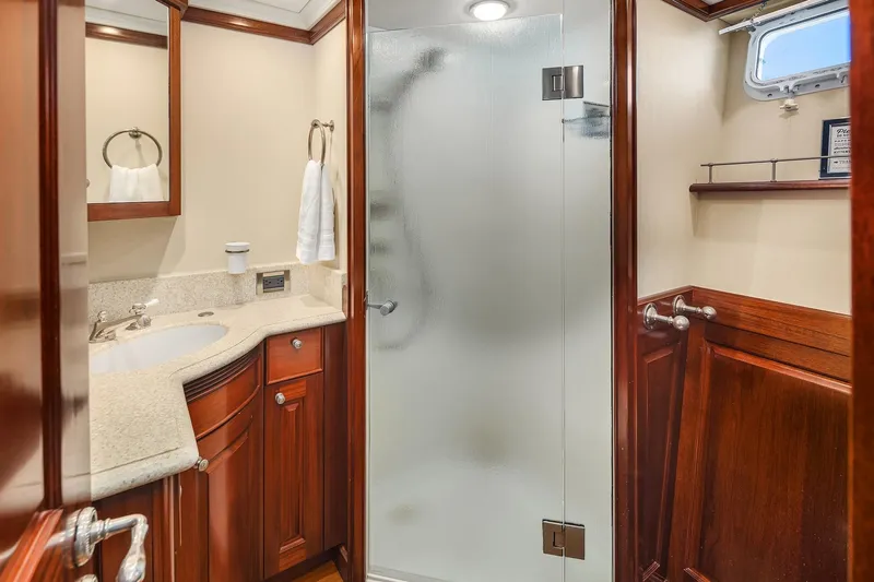 Jade Panama Yacht Photos Pics Luxurious bathroom on 2001 Rayburn Flush Deck yacht with wood accents and glass shower.