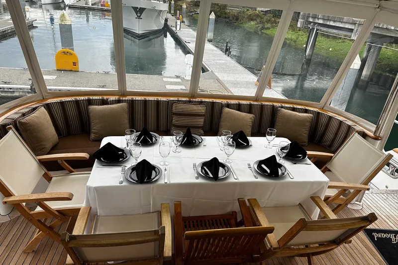 Jade Panama Yacht Photos Pics Elegant dining setup on 2001 Rayburn Flush Deck yacht, featuring tableware and cushioned seating.