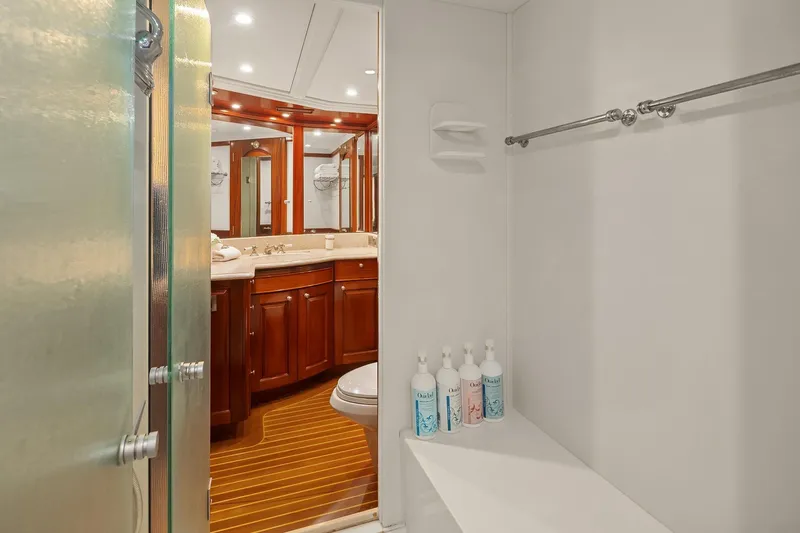 Jade Panama Yacht Photos Pics Luxurious bathroom on 2001 Rayburn Flush Deck yacht with wooden cabinetry and modern fixtures.