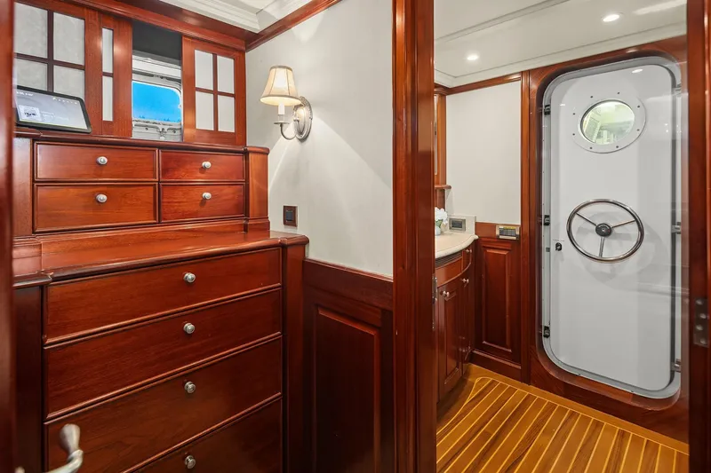 Jade Panama Yacht Photos Pics Luxurious 2001 Rayburn Flush Deck interior with elegant wood cabinetry and nautical door.