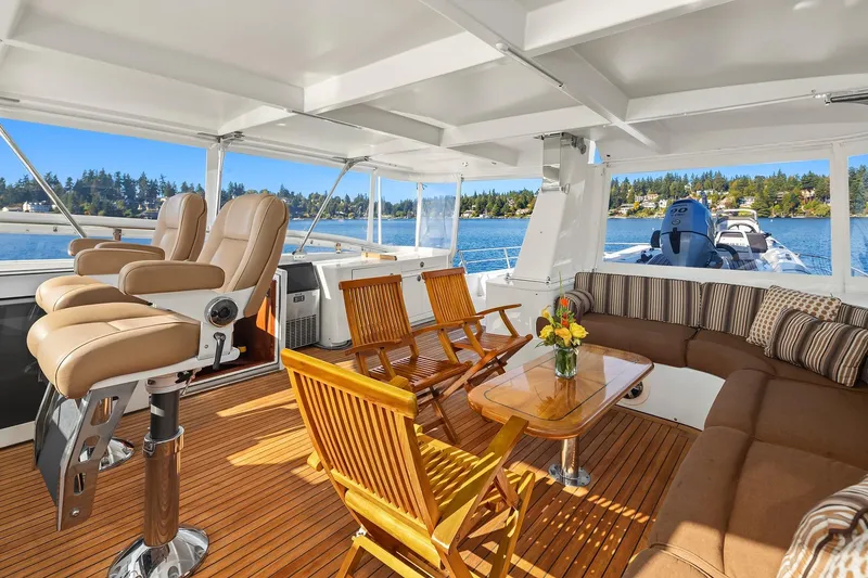 Jade Panama Yacht Photos Pics Luxurious 2001 Rayburn Flush Deck yacht interior with seating, table, and scenic water view.