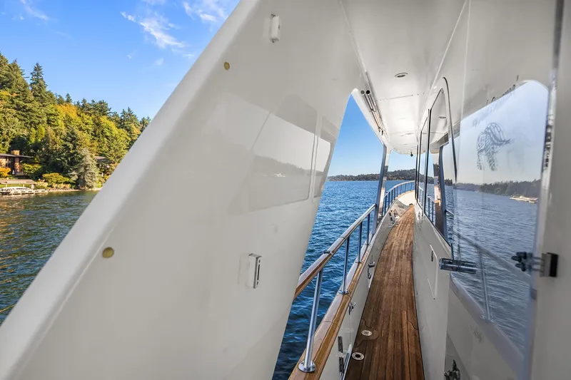 Jade Panama Yacht Photos Pics Side deck view of 2001 Rayburn Flush Deck yacht on a scenic lake.