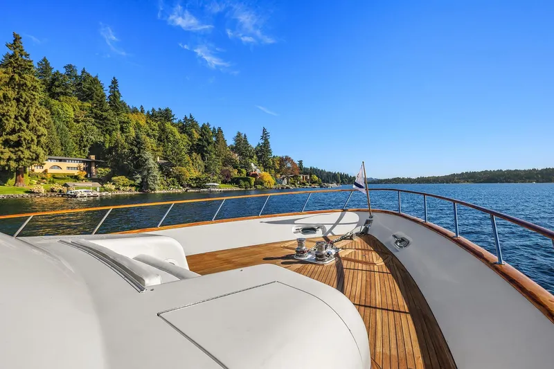 Jade Panama Yacht Photos Pics Luxurious 2001 Rayburn Flush Deck yacht cruising on a scenic lake with forested shoreline.