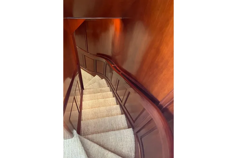 Jade Panama Yacht Photos Pics Elegant wooden staircase on 2001 Rayburn Flush Deck yacht interior.