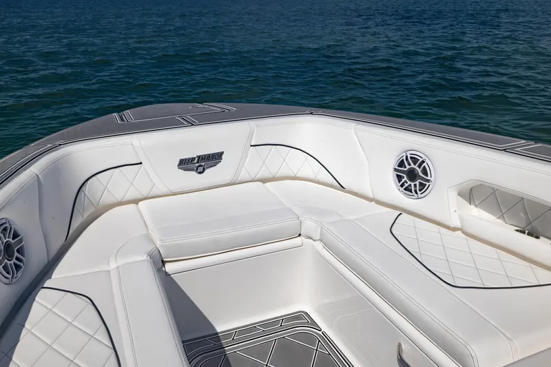 Yacht Photos Pics 2024 Deep Impact 399 Sport boat interior with white seating and ocean backdrop.