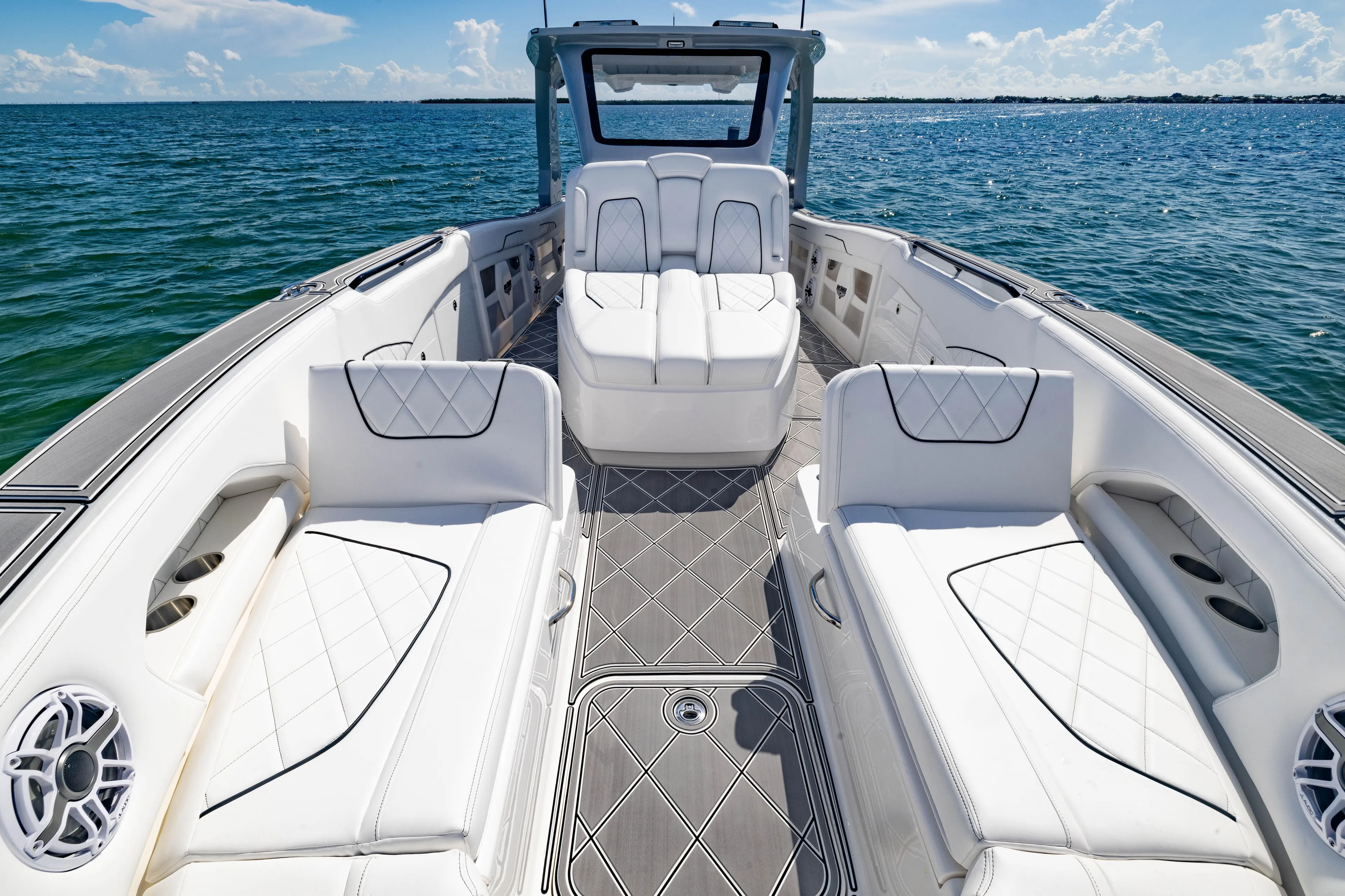  Yacht Photos Pics 2024 Deep Impact 399 Sport boat interior with luxurious white seating and ocean view.