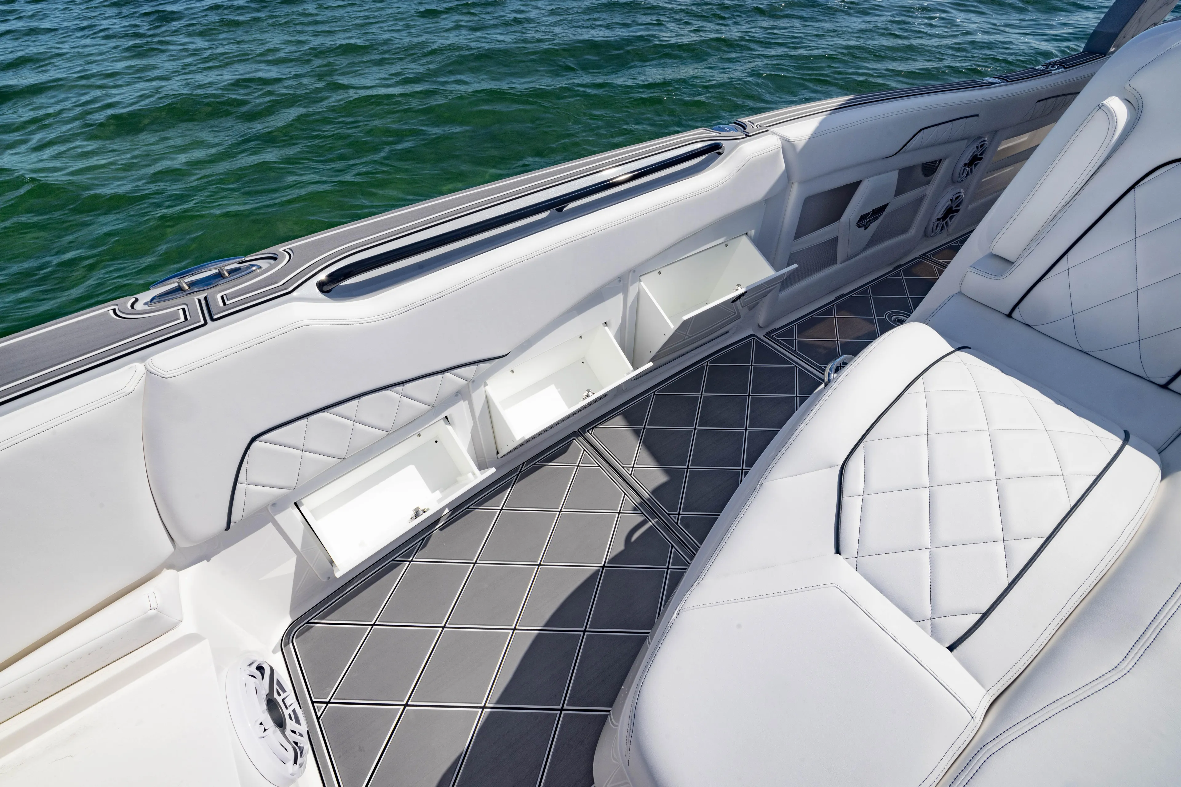  Yacht Photos Pics Luxurious interior of 2024 Deep Impact 399 Sport boat with white seating and storage compartments.