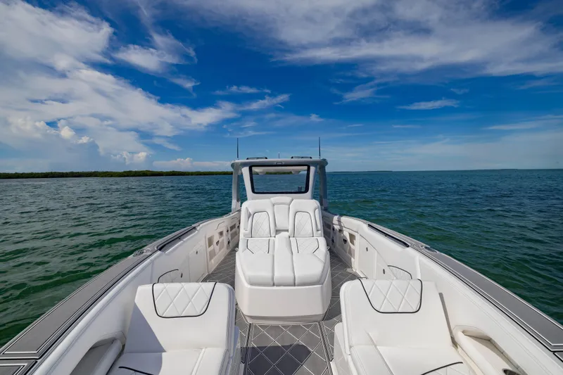  Yacht Photos Pics 2024 Deep Impact 399 Sport boat on open water under a clear blue sky.