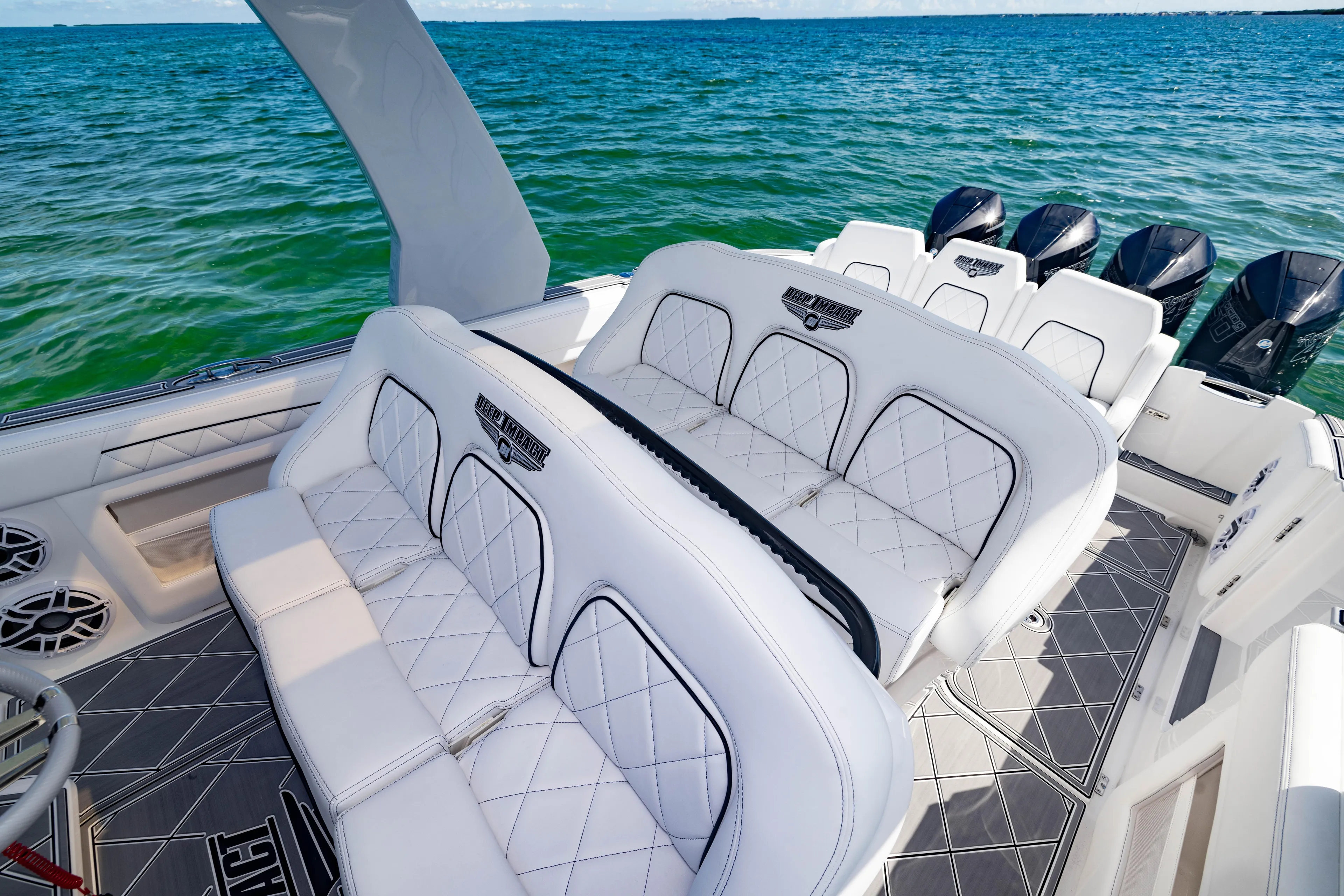  Yacht Photos Pics 2024 Deep Impact 399 Sport boat interior with luxurious white seating and ocean backdrop.
