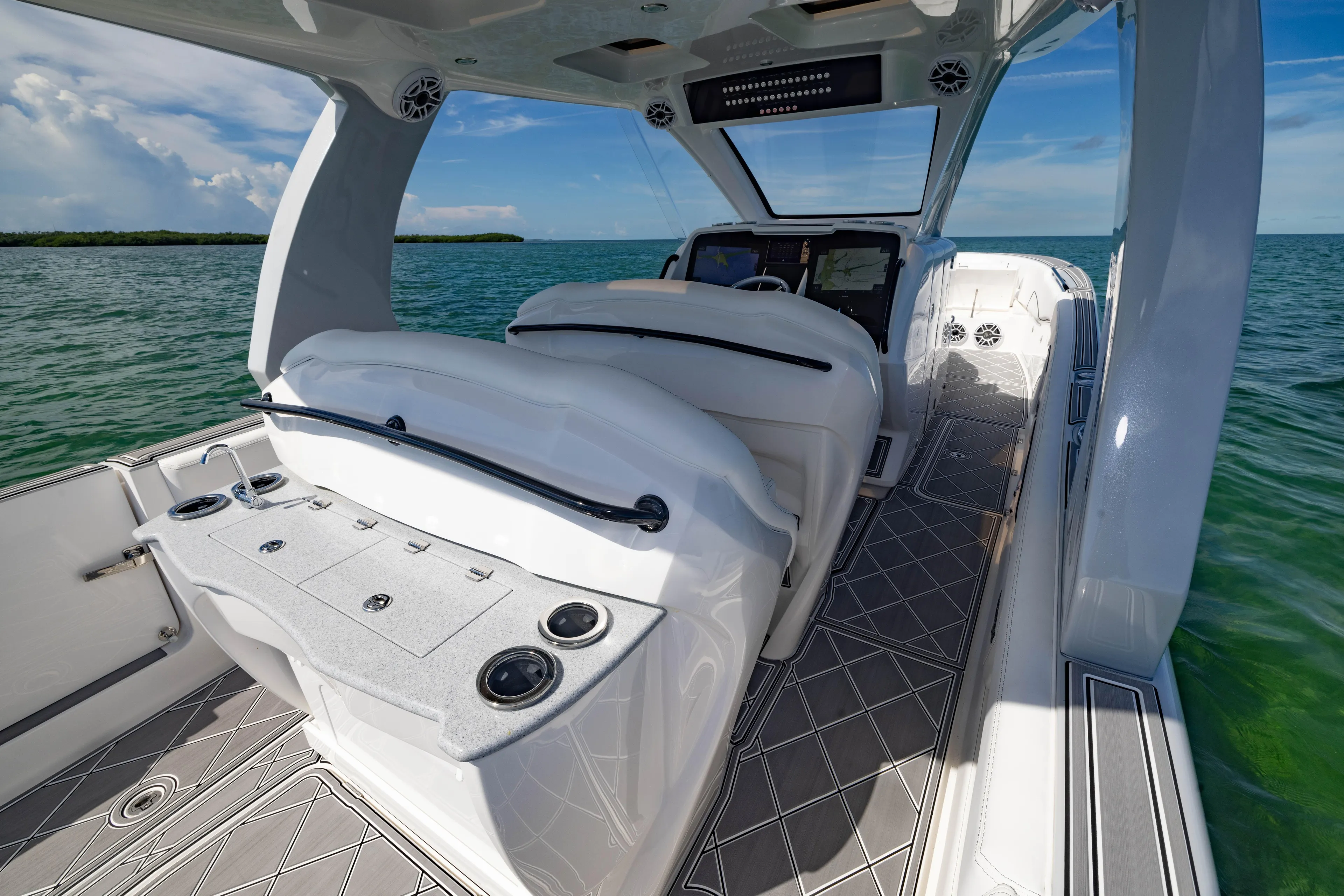  Yacht Photos Pics 2024 Deep Impact 399 Sport boat interior with sleek design and ocean view.
