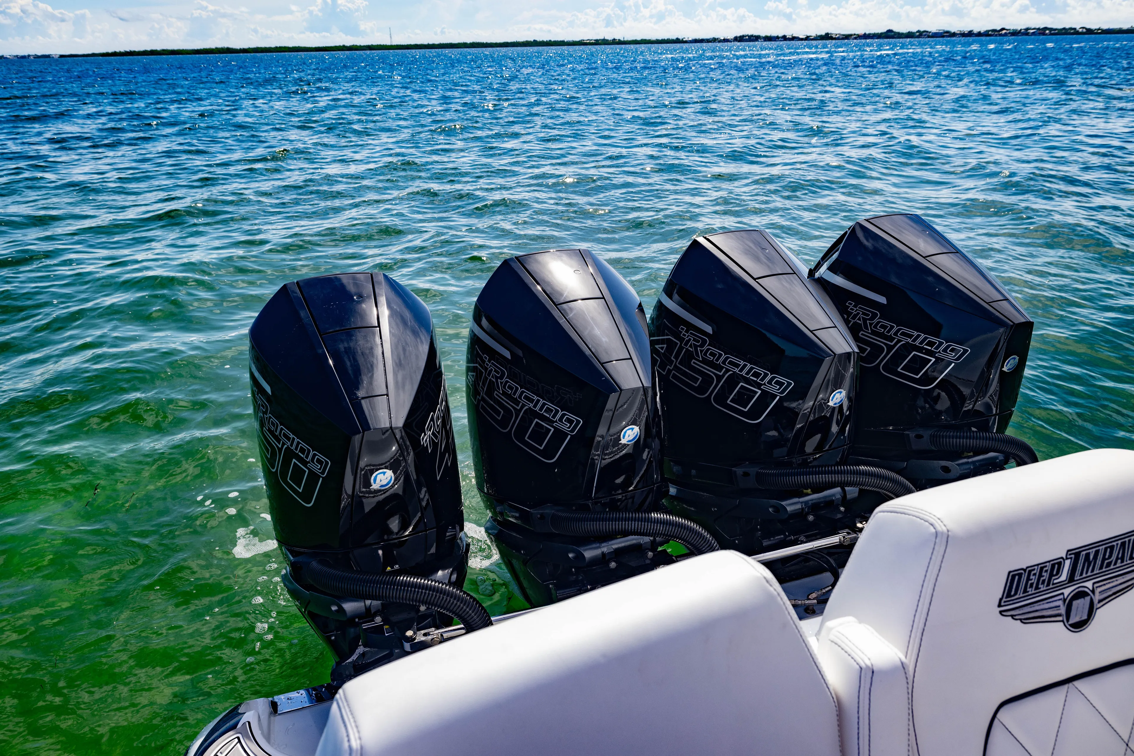  Yacht Photos Pics 2024 Deep Impact 399 Sport boat with four powerful outboard engines on open water.