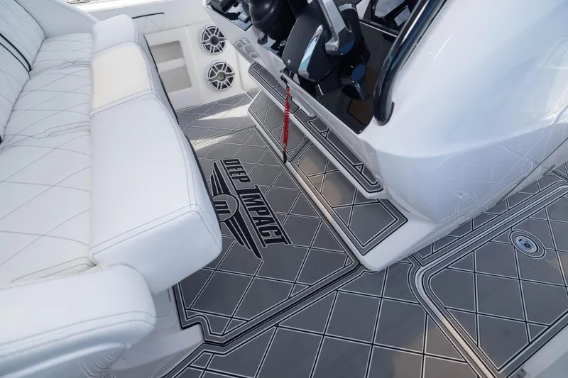  Yacht Photos Pics 2024 Deep Impact 399 Sport boat interior with white seating and custom flooring.