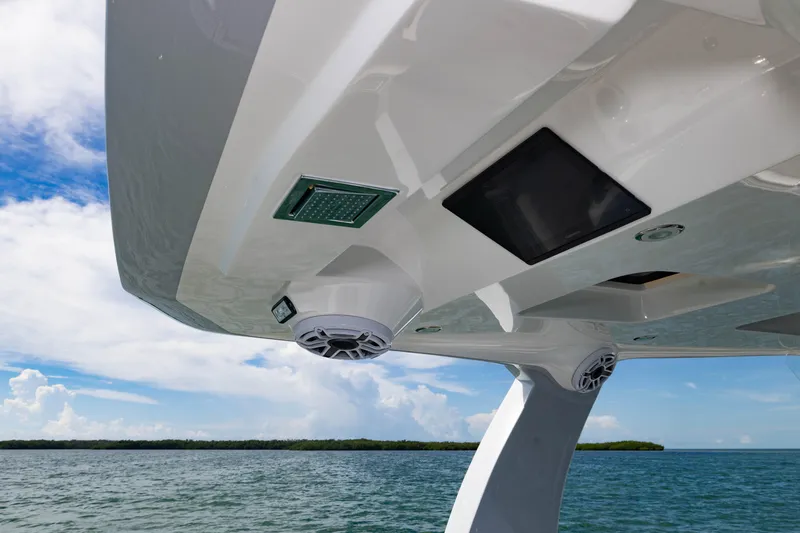  Yacht Photos Pics 2024 Deep Impact 399 Sport boat with advanced electronics and speakers, cruising on a sunny day.