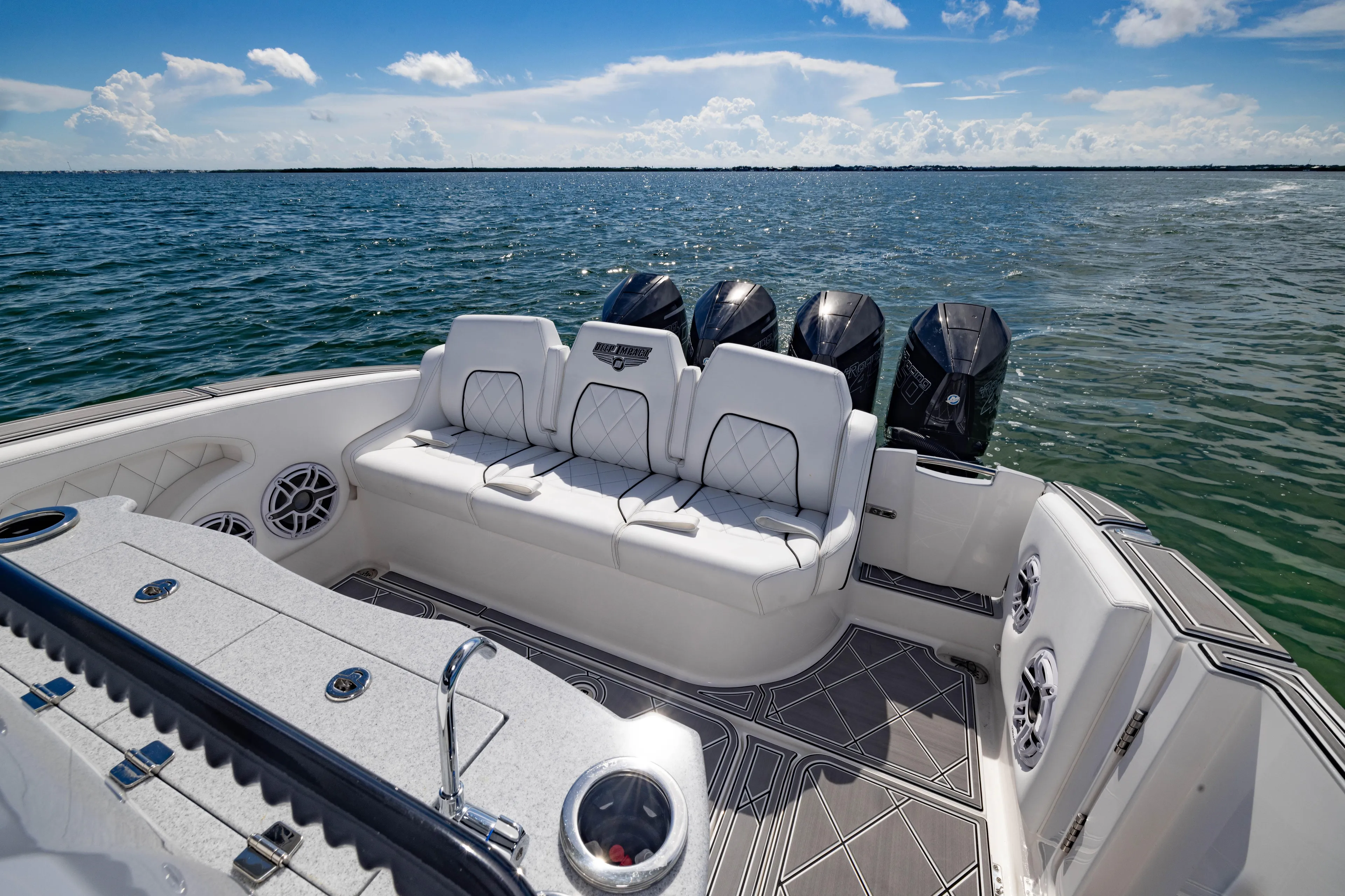  Yacht Photos Pics 2024 Deep Impact 399 Sport boat interior with luxurious seating and multiple outboard engines.