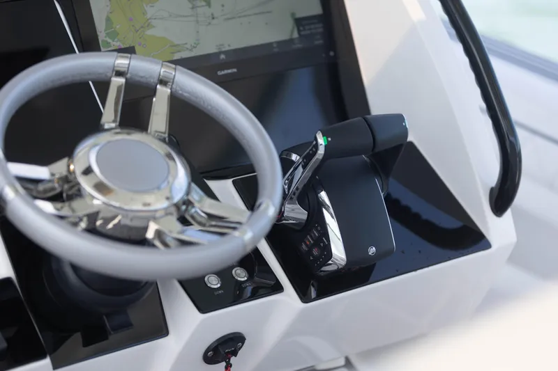  Yacht Photos Pics 2024 Deep Impact 399 Sport boat helm with steering wheel and throttle controls.