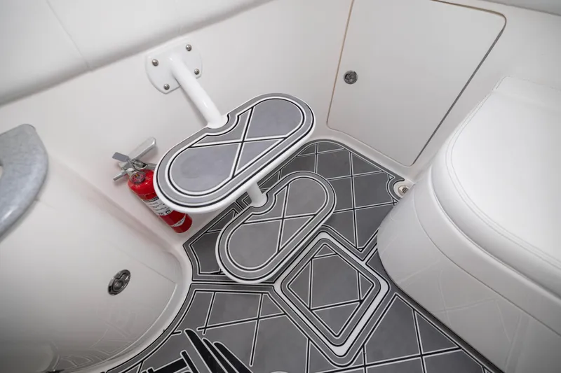  Yacht Photos Pics Interior of 2024 Deep Impact 399 Sport boat with stylish flooring and fire extinguisher.