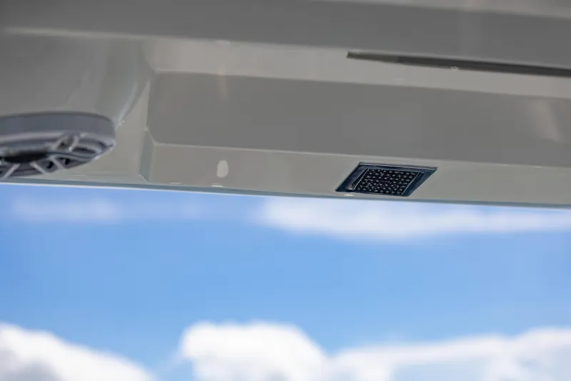  Yacht Photos Pics 2024 Deep Impact 399 Sport boat detail against blue sky background.