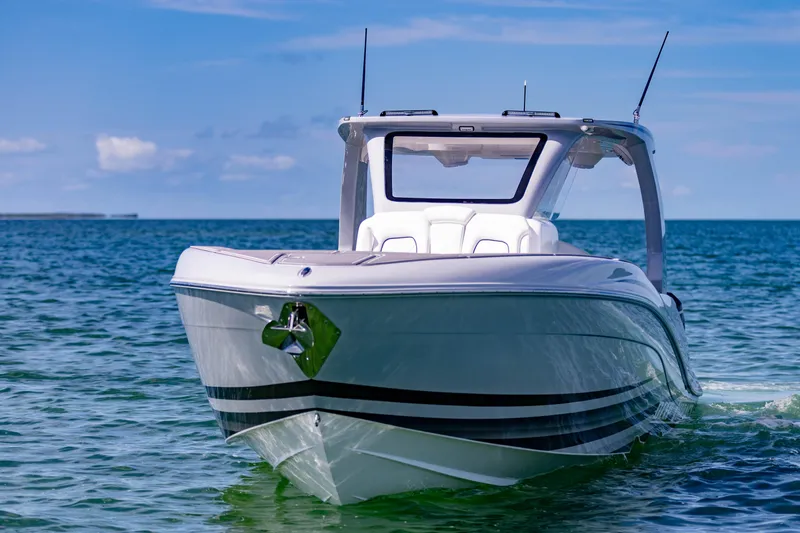  Yacht Photos Pics 2024 Deep Impact 399 Sport boat on clear blue water, front view.