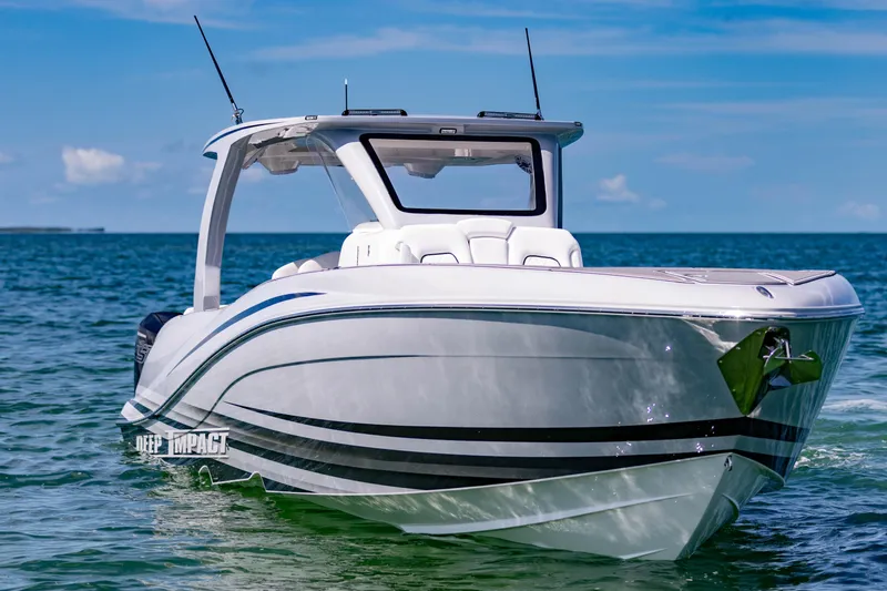  Yacht Photos Pics 2024 Deep Impact 399 Sport boat on clear blue water under a sunny sky.
