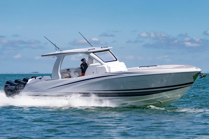  Yacht Photos Pics 2024 Deep Impact 399 Sport boat cruising on open water under clear skies.