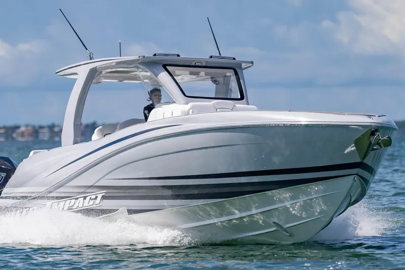  Yacht Photos Pics 2024 Deep Impact 399 Sport boat cruising on open water, showcasing sleek design and performance.