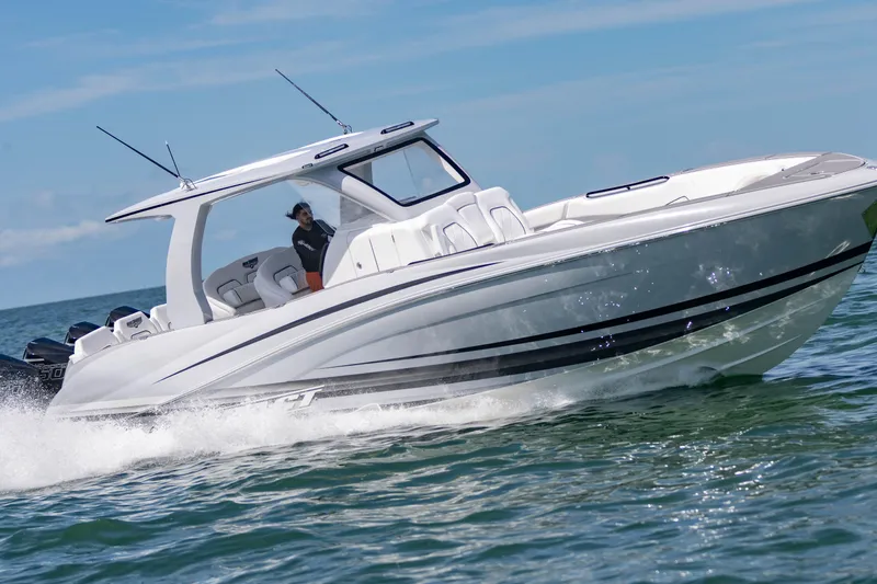  Yacht Photos Pics 2024 Deep Impact 399 Sport boat cruising on open water.