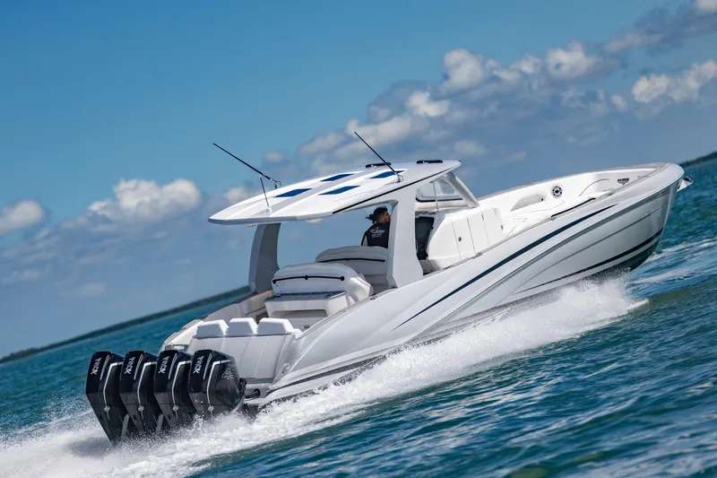  Yacht Photos Pics 2024 Deep Impact 399 Sport boat cruising on open water, showcasing sleek design and powerful engines.
