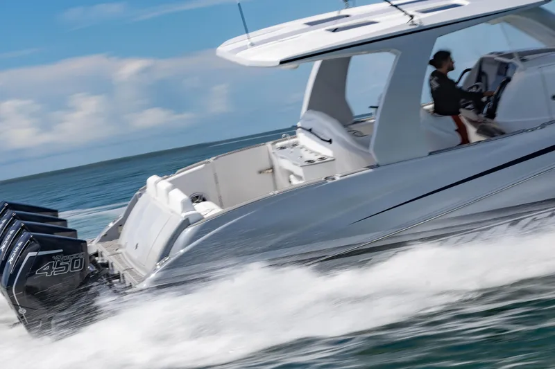  Yacht Photos Pics 2024 Deep Impact 399 Sport boat speeding on water with powerful engines.