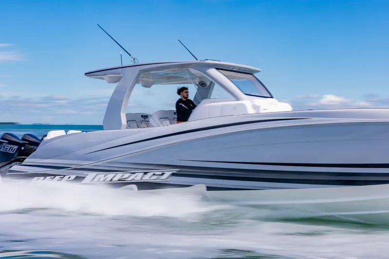  Yacht Photos Pics 2024 Deep Impact 399 Sport boat cruising on open water, showcasing sleek design.