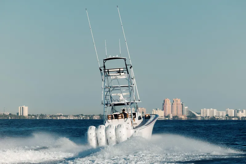  Yacht Photos Pics 2026 Front Runner 47 Center Console boat cruising on open water with city skyline backdrop.