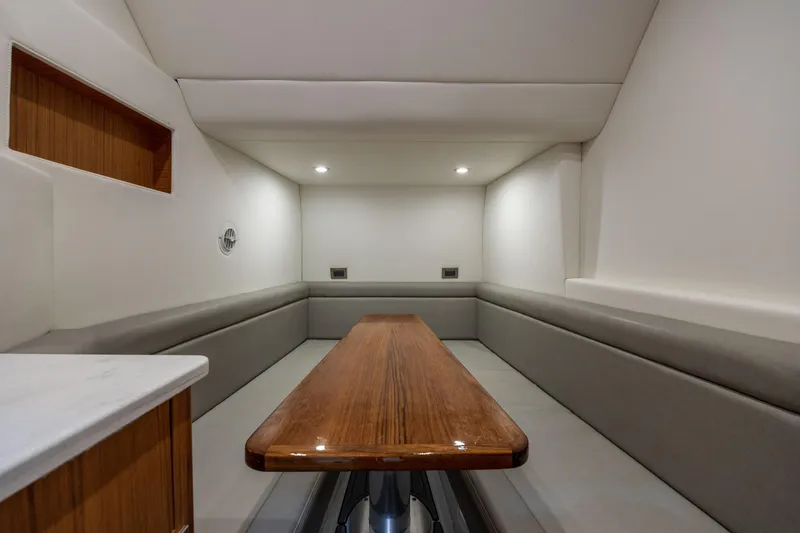  Yacht Photos Pics Interior of 2026 Front Runner 47 Center Console, featuring sleek seating and wooden table.