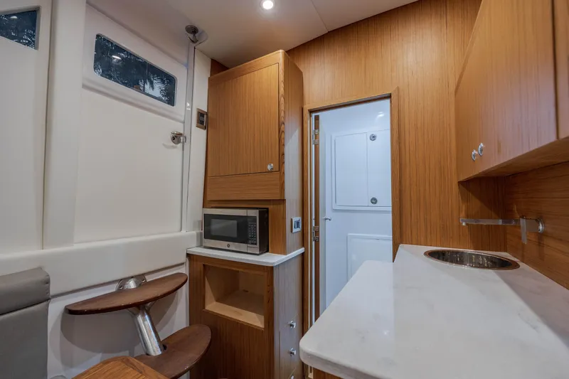  Yacht Photos Pics Interior of 2026 Front Runner 47 Center Console with kitchenette and seating area.