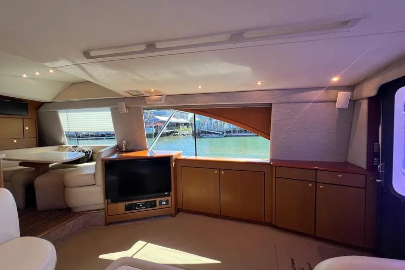 Reel Interest Yacht Photos Pics Interior of 2002 Ocean Yachts 56 Super Sport with elegant wood cabinetry and waterfront view.