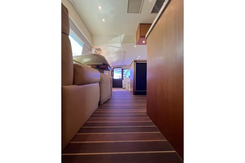 Reel Interest Yacht Photos Pics Interior view of 2002 Ocean Yachts 56 Super Sport, featuring elegant wood flooring and modern design.